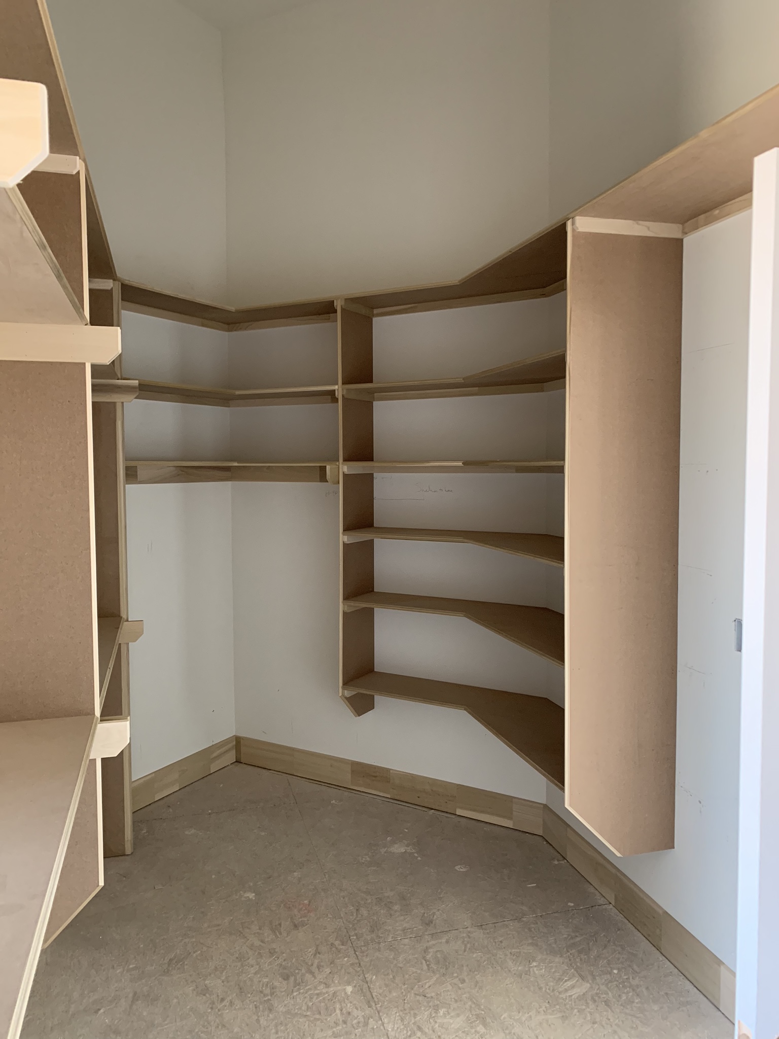 Custom walk-in pantry shelving installation by Ruach Custom Carpentry in Columbus, Ohio, featuring handcrafted wood shelving units designed for maximum kitchen storage and organization. This custom carpentry project highlights expert finish carpentry, built-in shelving solutions, and precision woodwork tailored to fit the unique layout of a modern pantry space in a Central Ohio home.