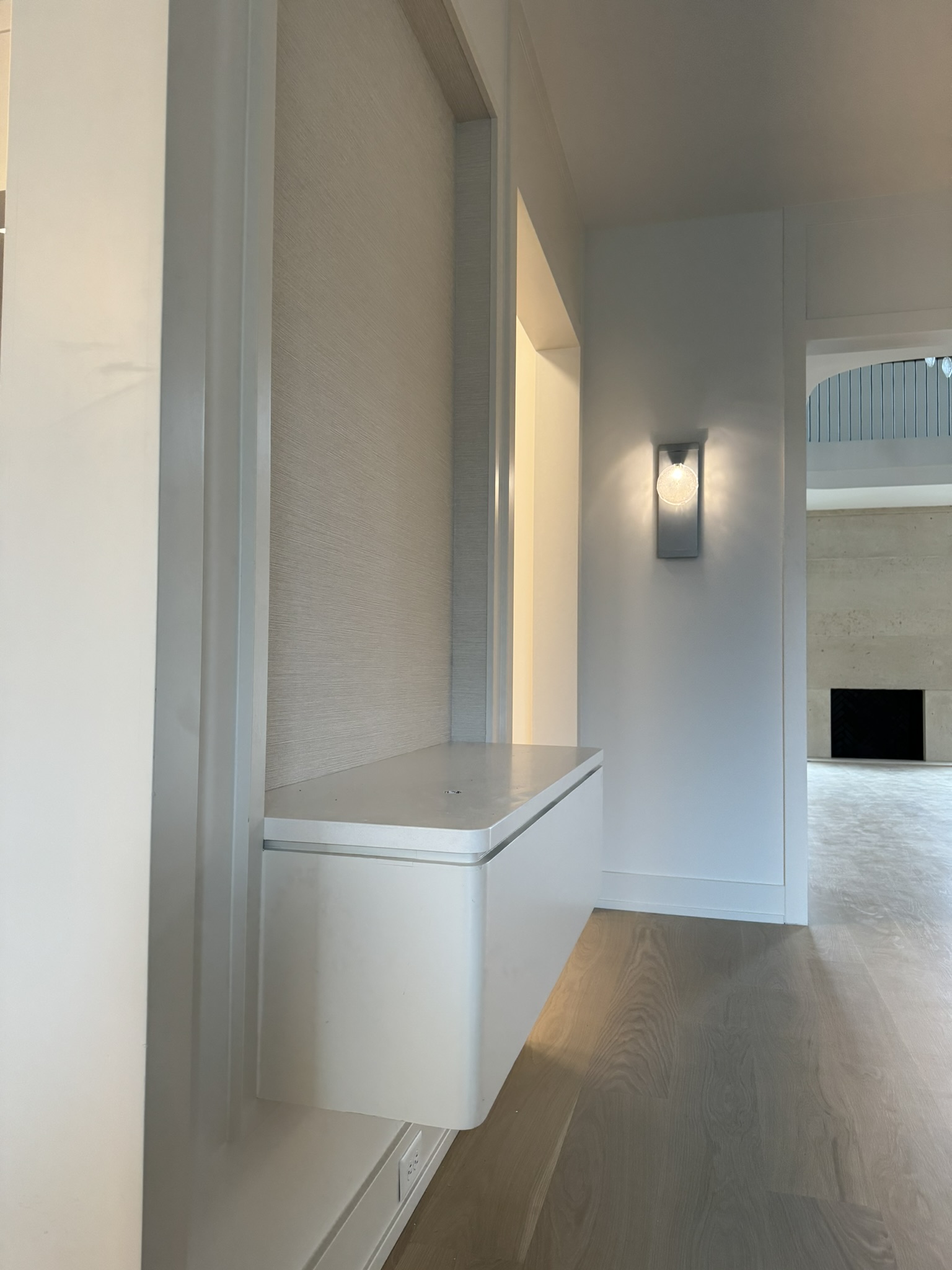 Custom floating wall-mounted cabinet installation by Ruach Custom Carpentry in Columbus, Ohio, featuring a modern rounded-edge design with a seamless, minimalist profile. This custom carpentry project highlights expert finish carpentry, contemporary built-in furniture solutions, and precision craftsmanship, adding functional storage and sleek architectural detail to a luxury Central Ohio home.