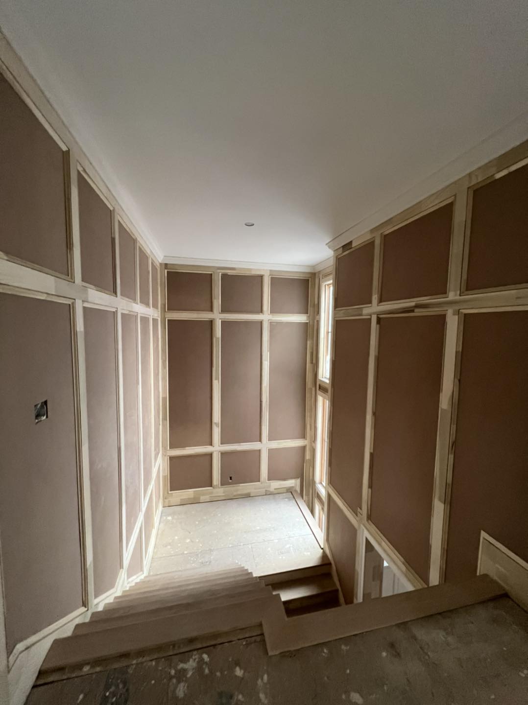 Full-height custom wainscoting and wall paneling installation along a stairwell by Ruach Custom Carpentry in Columbus, Ohio, featuring handcrafted trim work, raised panels, and detailed finish carpentry. This custom carpentry project highlights precision woodwork, elegant architectural wall treatments, and expert craftsmanship designed to enhance the beauty and character of a luxury Central Ohio home.