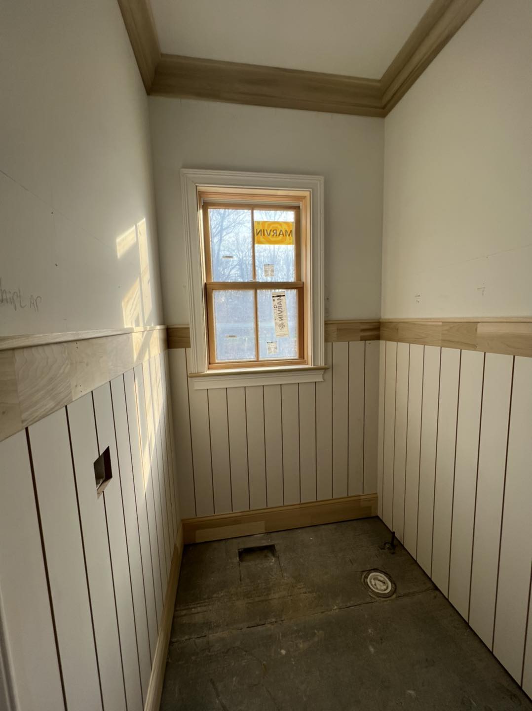 Custom vertical wainscoting installation and detailed crown molding by Ruach Custom Carpentry in Columbus, Ohio, featuring handcrafted vertical paneling, custom window trim, and elegant crown molding to elevate this small space with timeless craftsmanship. This finish carpentry project brings beautiful architectural character and high-end custom woodwork to a luxury Central Ohio home.